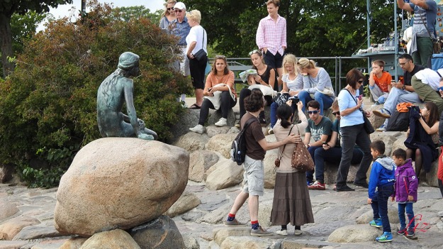 The Little Mermaid, bronze sculpture by Edvard Eriksen, appears weary of all the onlookers. She was inspired by the fairy tale of the same name by Hans Christian Andersen. She has been sitting on this rock since 1913.